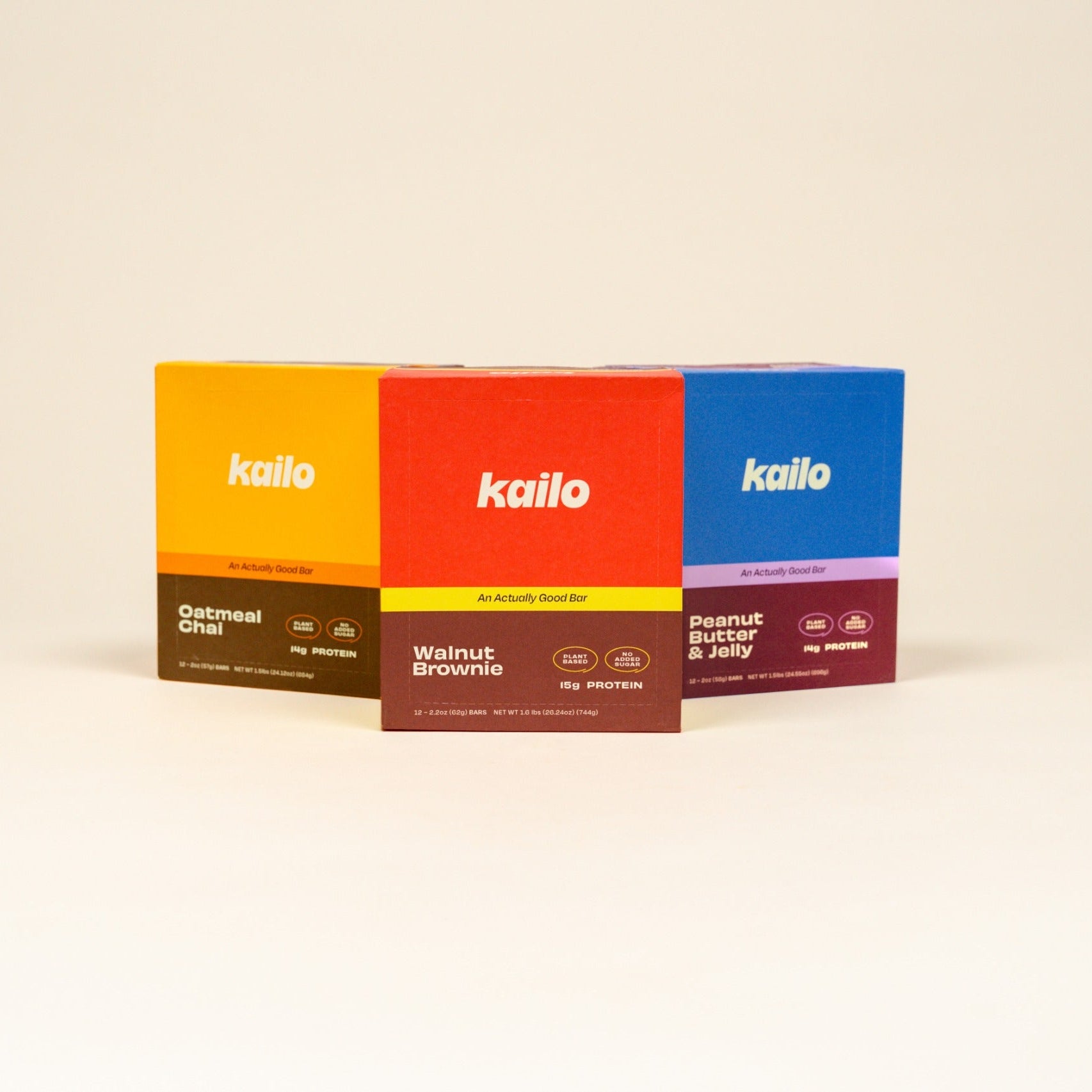 Four colorful boxes of Kailo Protein Bars on a beige background