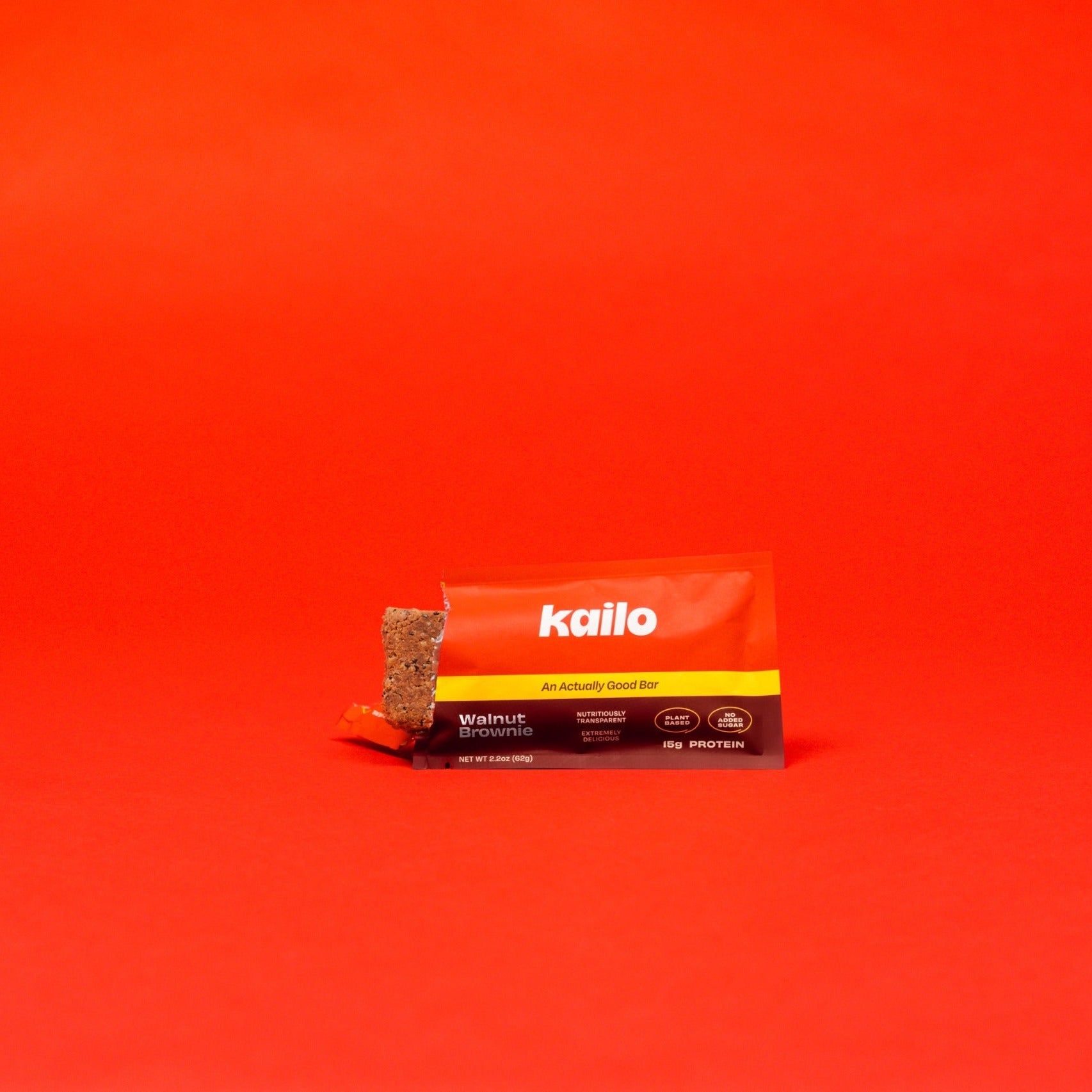 Kailo Walnut Brownie Protein Bar on a Red Background