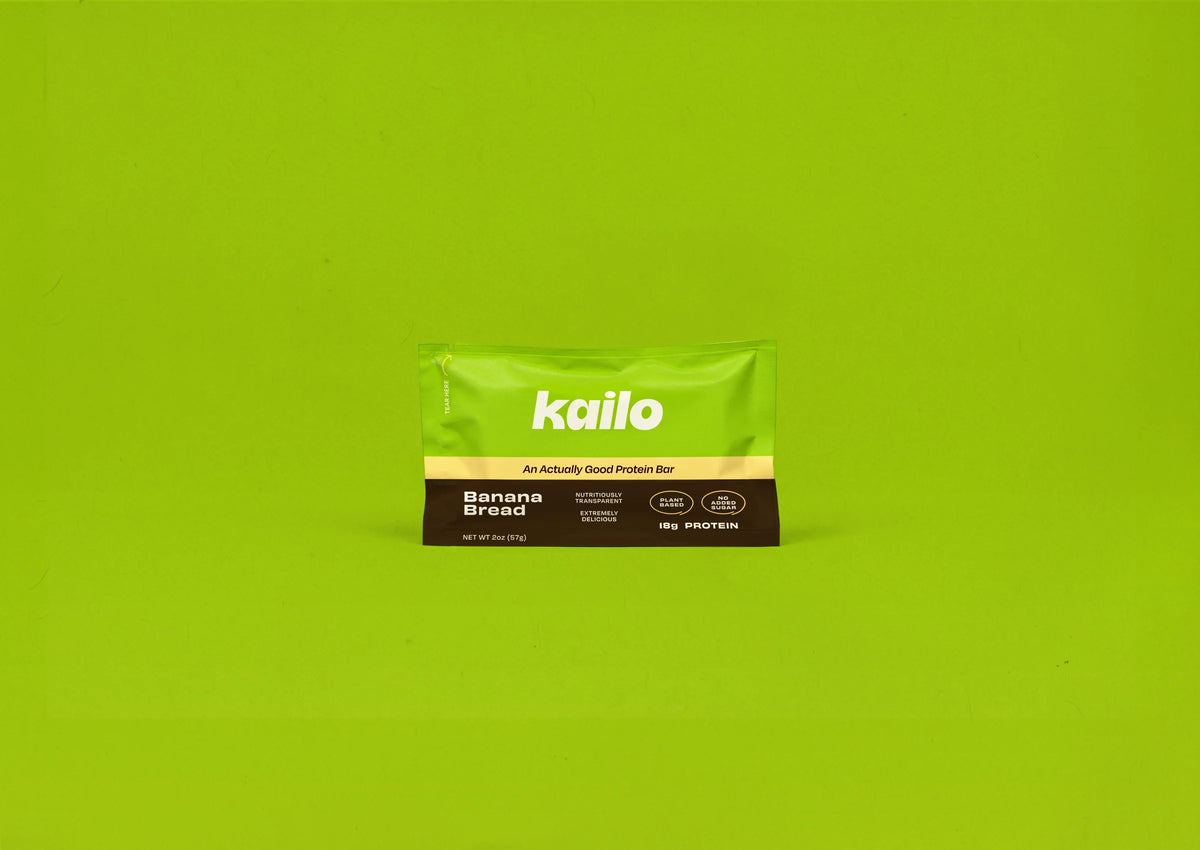 Kailo Banana Bread protein bar pouch on a green background