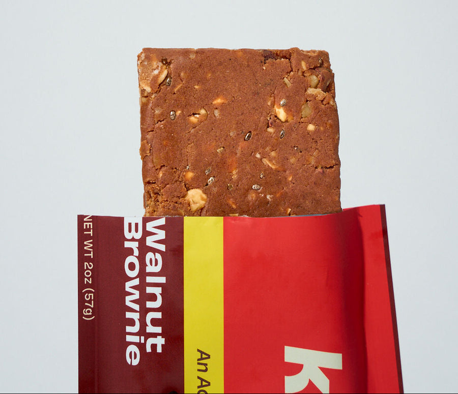 A Kailo Walnut Brownie bar broken open to show the texture