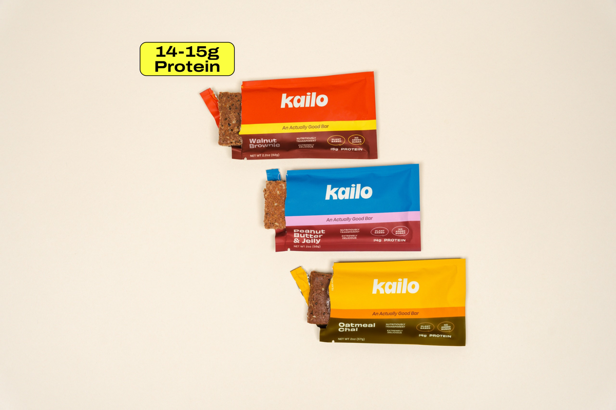 Three Kailo protein bars, Walnut Brownie, Peanut Butter and Jelly, and Oatmeal Chai, with a badge reading 14-15g protein