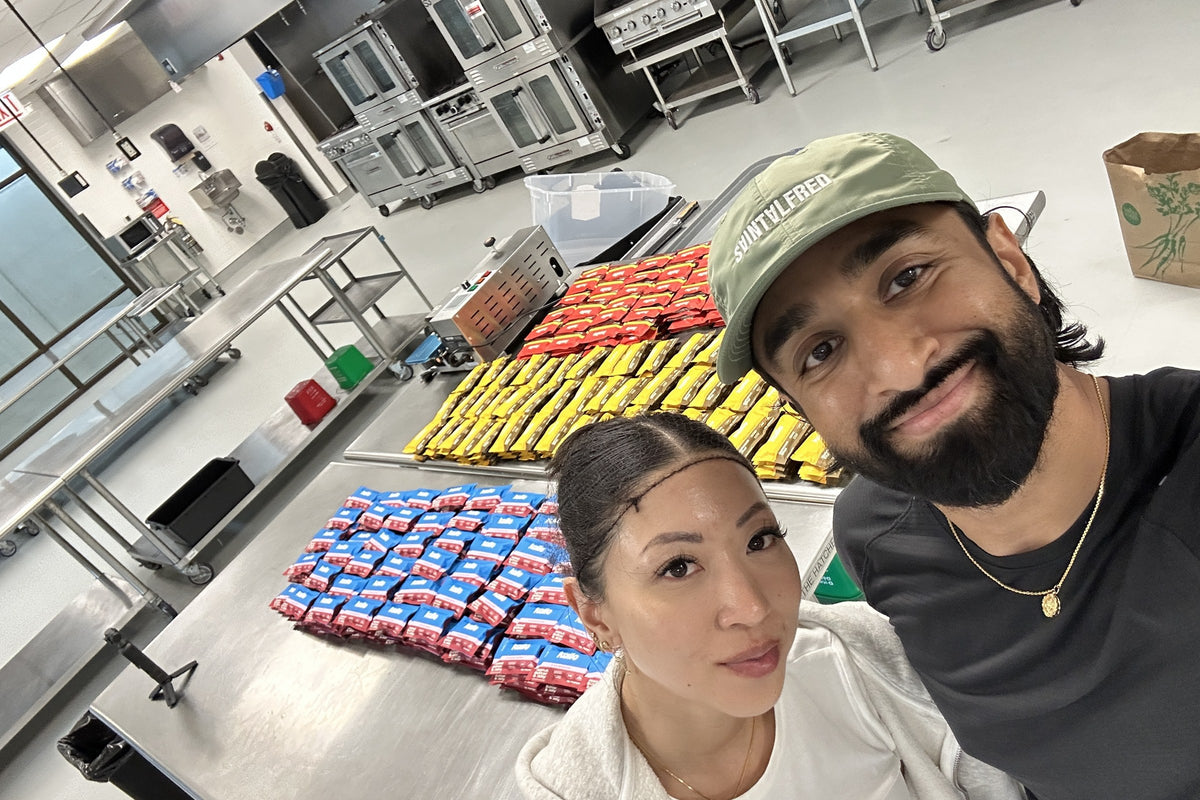 Sri and Julia in the Chicago kitchen beside a table of freshly wrapped Kailo bars